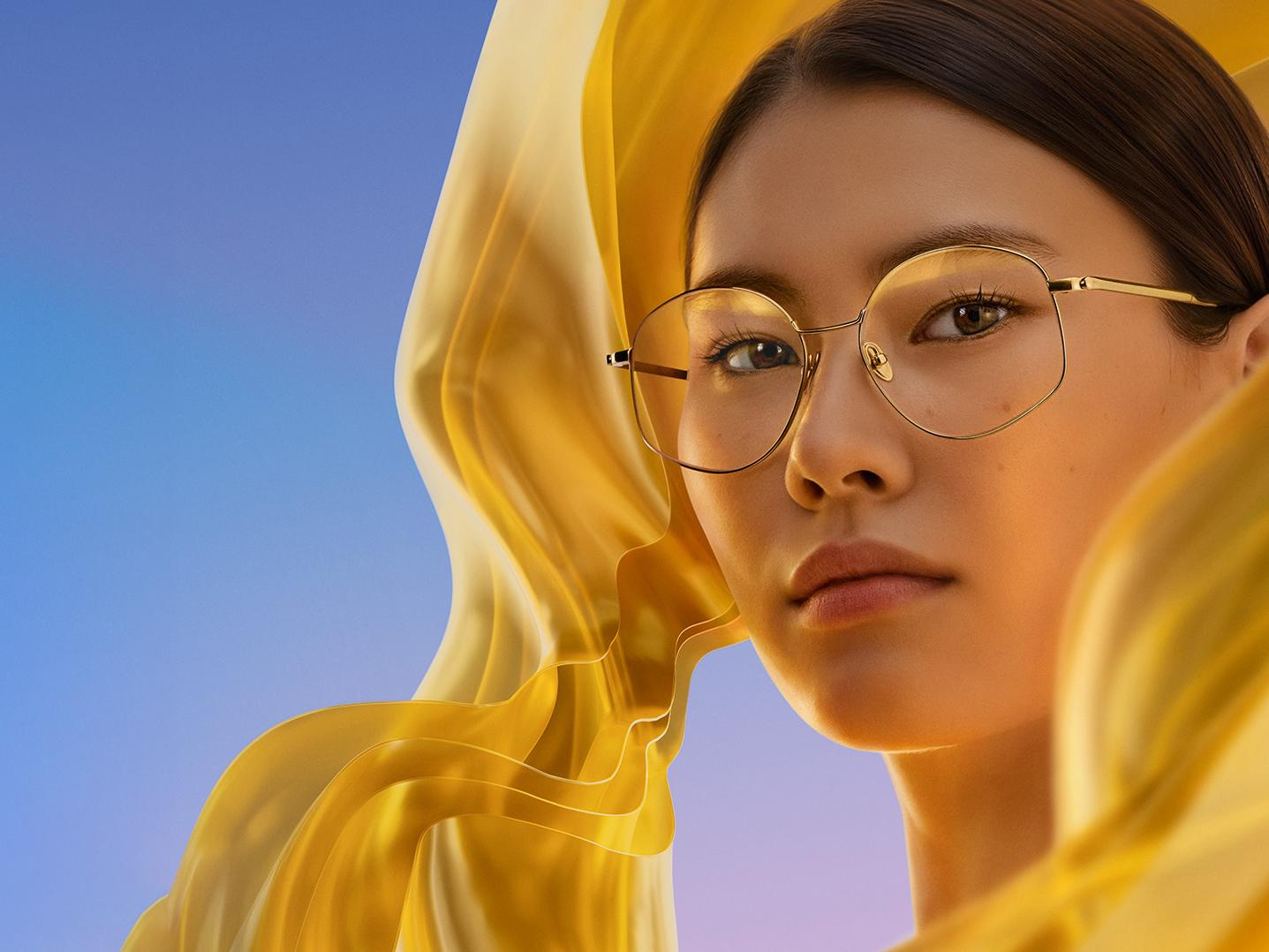 A woman wearing clear spectacles with ZEISS DuraVision Gold UV, adding a subtle but distinctive golden reflex to the lenses.